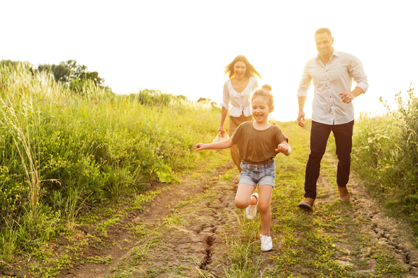 Kids Running in Field with Parents