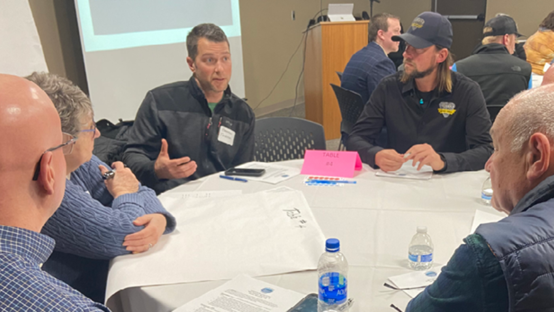 Individuals in a meeting for East Bay Township